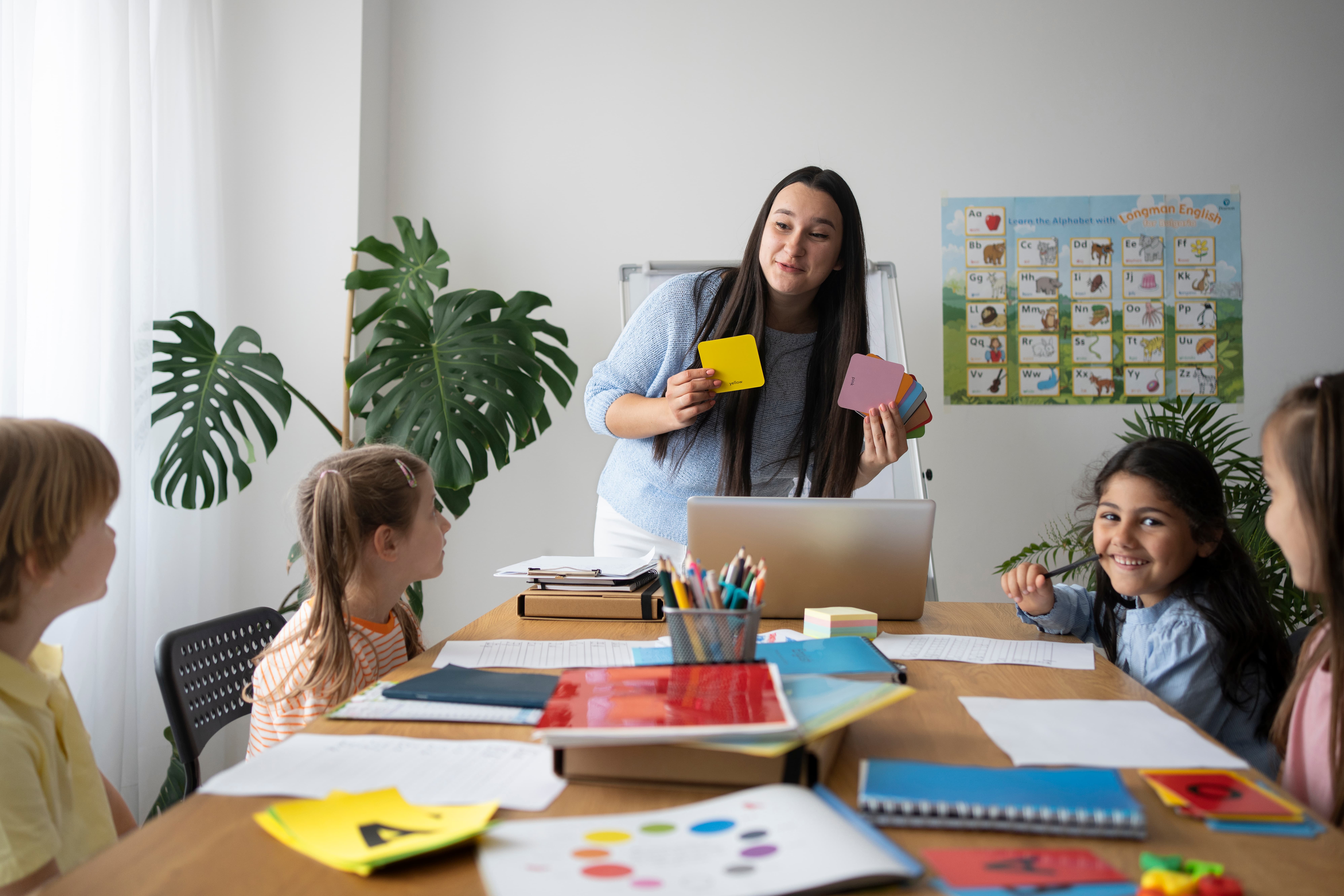 front-view-smiley-teacher-explaining-kids-autism-classroom