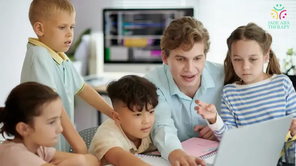 teacher-guiding-children-during-small-group-computer-lesson