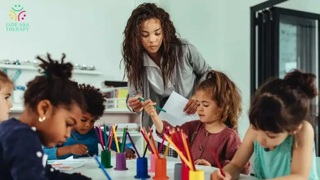 teacher-helping-children-with-art-activity-in-classroom